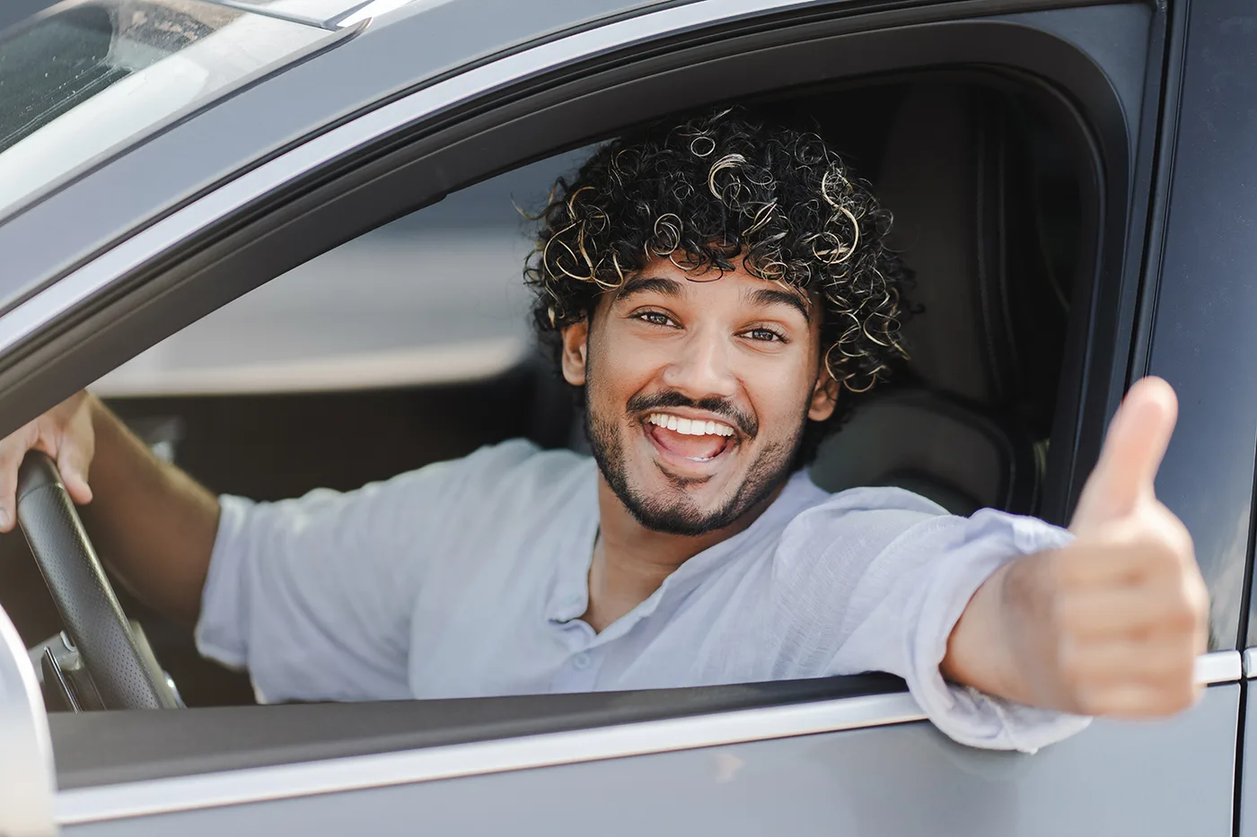 Driver giving a thumbs up from his clean car