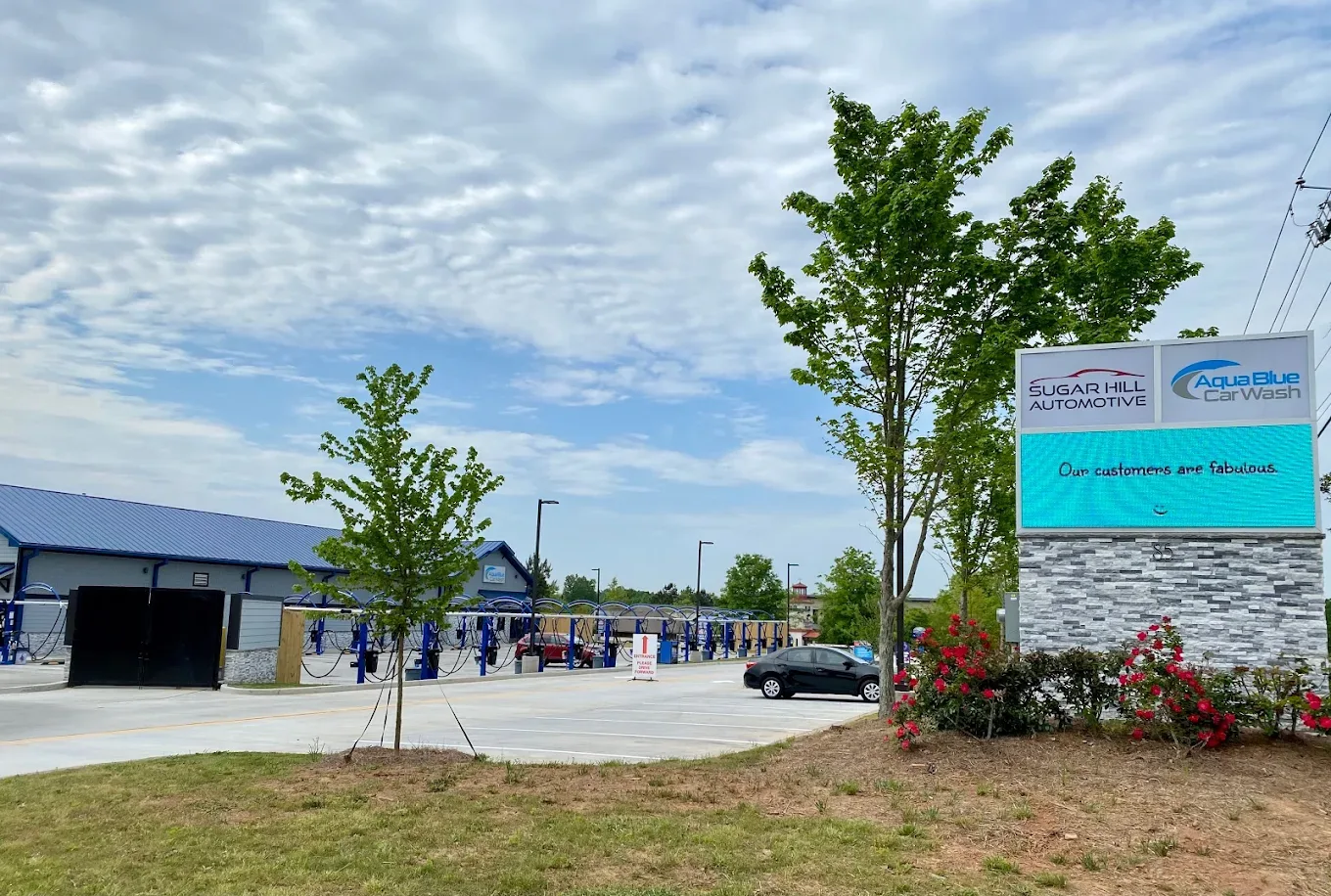 The Aqua Blue Car Wash building under a blue sky